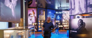 Image of man standing in National Museum of African American Music. He's surrounded by museum displays.